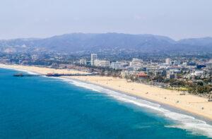 Santa Monica State Beach, in the back residential buildings, Santa Monica Pier and the mountains